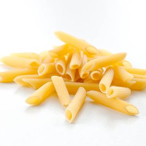 dry uncooked pasta tubes, penne, on white background